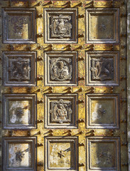 Detail of the door on the main facade of the Basilica of Saint Eustorgio. View from Piazza Sant'Eustorgio square. Milan, Lombardy, Italy.