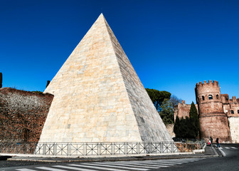 Fototapeta na wymiar Rome street view of the Pyramid of Cestius seen from Ostiense Square