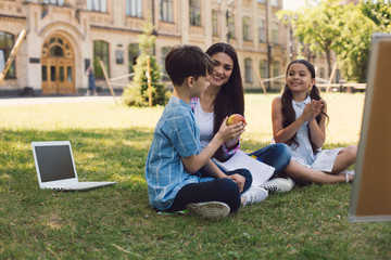 Teacher giving apple to kid