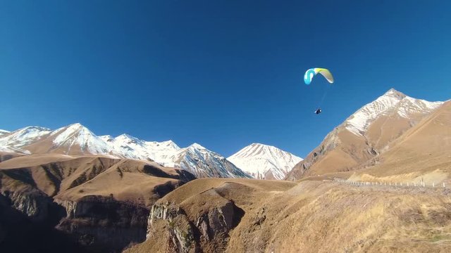 Paragliding - Caucasus Mountains, Friendship Monument, Caucasia, Gudauri, Georgia, Europe / Asia.