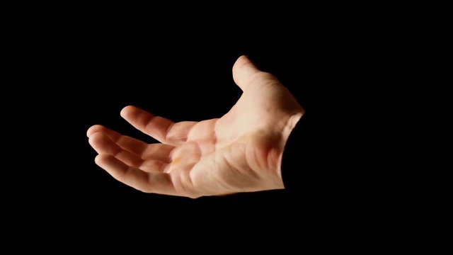 Male hand clenched infist in rays of light isolated on black background. Fingers slowly open themselves and show empty palm, then clenched back into fist. Presentation concept, slow motion video.