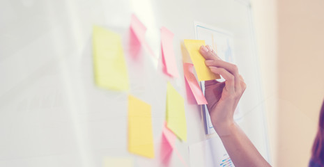Business people meeting at office and use post it notes to share idea. Brainstorming concept....