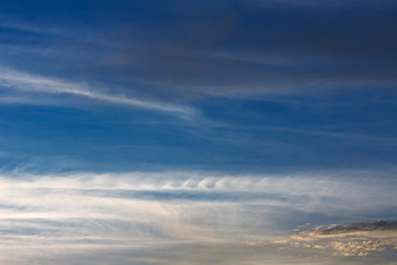 Naklejka na ściany i meble Feathery curls Kelvin-Helmholtz. Kelvin, Helmholtz instability clouds wavy on blue sky
