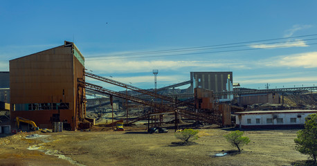 Fototapeta na wymiar Old mining complex of Riotinto with mineral conveyor belts and old mining buildings
