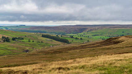 Fototapeta na wymiar Grey clouds over the North Pennines landscape near Allenheads in Northumberland, England, UK