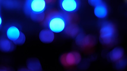 defocused colored lights shining, glittering festoon shines with multicolored lights. close-up