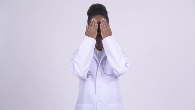 Young African woman doctor covering eyes as three wise monkeys concept
