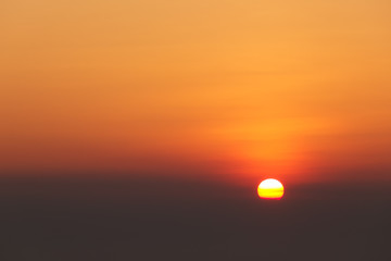 Sun with cloudy sky at sunset.