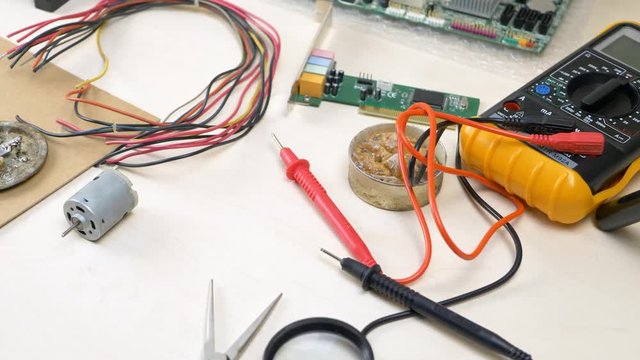 Workplace with electronic components in electronics workshop. Repair Shop and Electronic Devices Concept