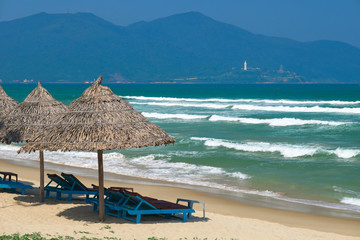 Beach umbrellas and deck chairs at the China Beach, DaNang, Vietnam.