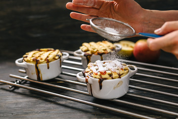 woman sprinkle sugar over apple pie