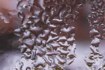 Water drops on glass window close up with blurred background. Drops in macro. Condensate on window...