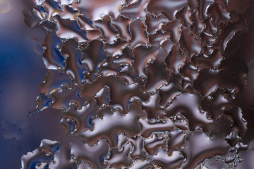 Water drops on glass window close up with blurred background. Drops in macro. Condensate on window closeup. Wet air.