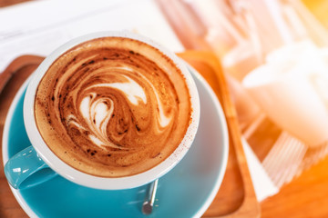 Late art coffee with heart shape on wood table background. Top view.