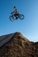 BMX Bike jump over a dirt trail