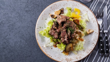 Roasted  veal  with vegetables. Tasty beef salad.  Top view. Copyspace