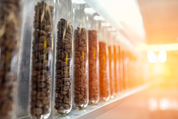Coffee bean in glass tubes with sunlight.