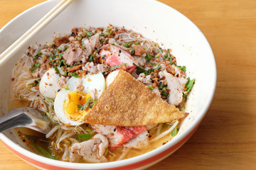 Spicy pork Tom yam noodle on table.