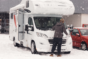 camping car or campervan getting ready in the parking space and man clean it for outdoor journey on...
