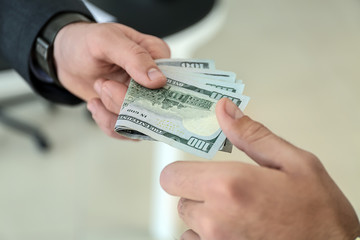 Businessman taking bribe from man in office. Concept of corruption