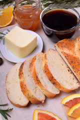 Sliced wheat bread surrounded by butter and orange pieces
