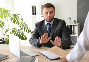 Businessman refusing to take bribe in office. Concept of corruption