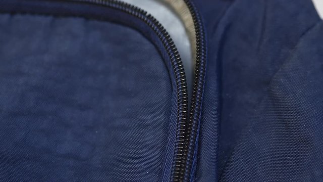 Unzipping Zipper On The Backpack