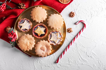 Plate with tasty mince pies on table