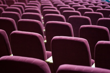 Red velvet seats for spectators in the theater or cinema