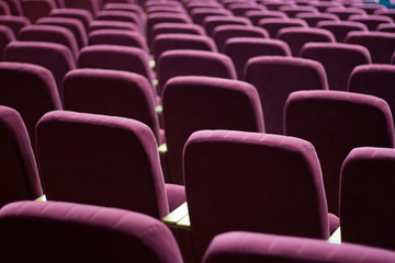Obraz premium Red velvet seats for spectators in the theater or cinema