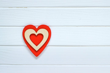 Red heart on white wooden background. Valentines day concept. Top view.