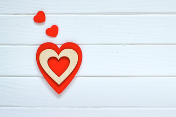 Red heart on white wooden background. Valentines day concept. Top view.