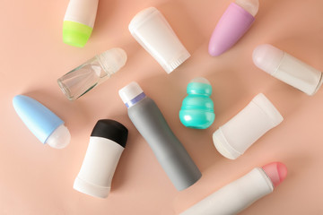 Different deodorants on color background