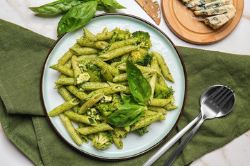 Plate with tasty pesto pasta on table - Powered by Adobe
