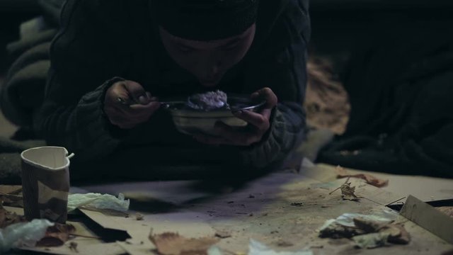 Volunteer giving bowl with soup hungry homeless person, social support for bums