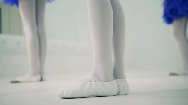 Close up of girl's small feet in process of ballet training