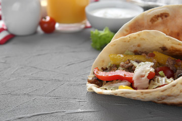 Tasty taco on grey table