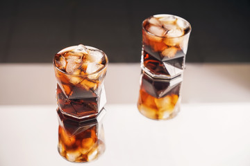 Glasses of tasty cold cola drink on table