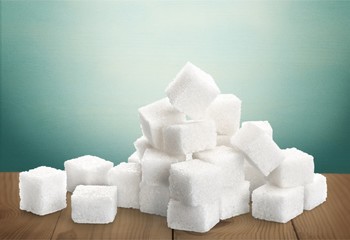 Cubes of sugar on white background