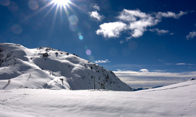 the sun's rays illuminate the snow at high altitude - obrazy, fototapety, plakaty