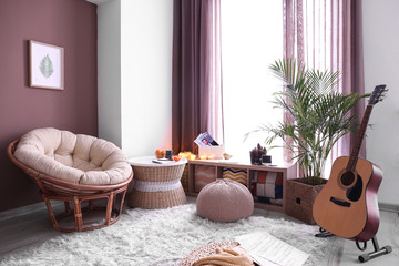 Stylish interior of living room with comfortable lounge armchair