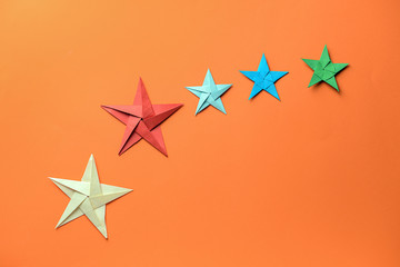 Fototapeta na wymiar Origami stars on color background