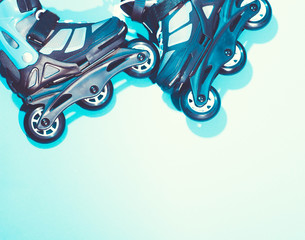  roller skates on a blue background headphones sports equipment rollers wheels active leisure style...