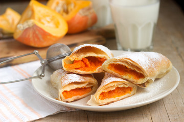 Traditional Romanian or Moldovan pumpkin strudel vertuta served with milk. Rustic style.