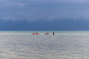 Kayaking in the azure sea at the stormy blue sky background in Koh Samui island, Thailand