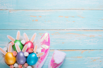 Easter multi-colored eggs and rabbit ears. Flat lay