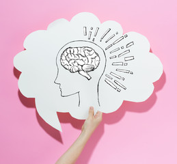 Brain illustration with a speech bubble on a pink background