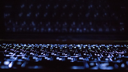 Laptop keyboard and its reflection.