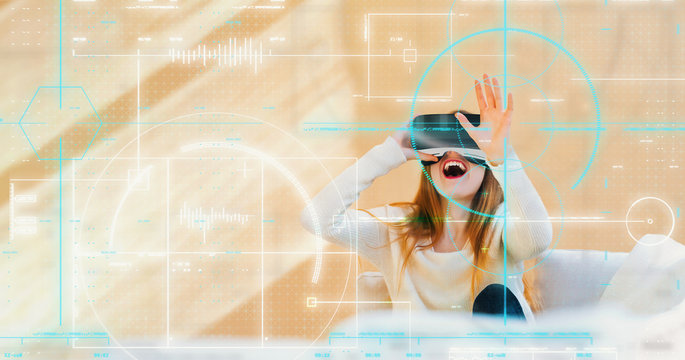 Happy young woman using a virtual reality headset technology theme