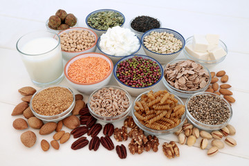 Health food for vegans with tofu bean curd, legumes, pasta, grains, cereals, nuts, seeds, almond milk, butter and yoghurt. High in antioxidants, dietary fibre, omega 3 and vitamins.